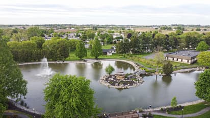 Drone photo over Greenfield park and water 